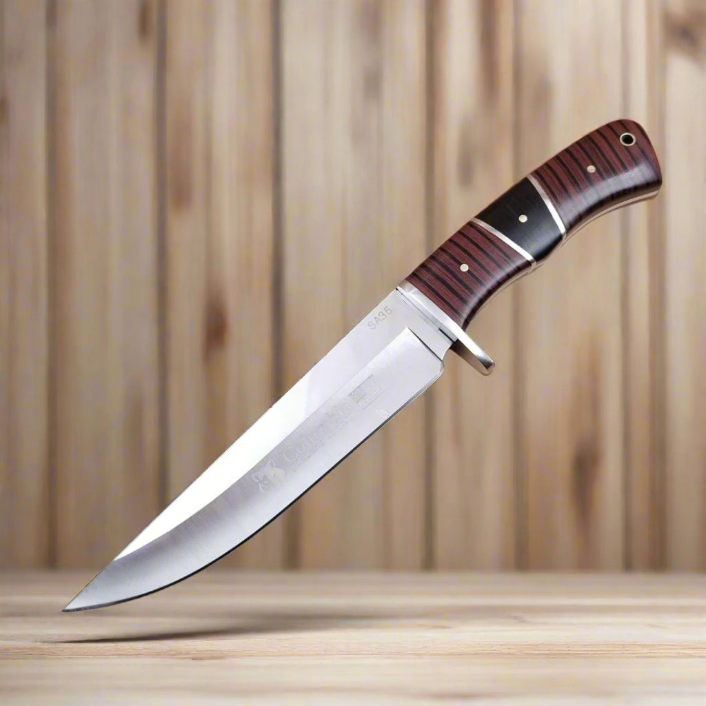 A Columbia brand knife with a black sheath and a wooden handle featuring a striped pattern.