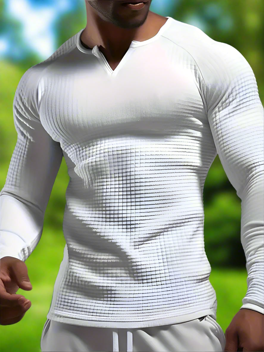 A person wearing a white long sleeve active shirt with a V-neck.