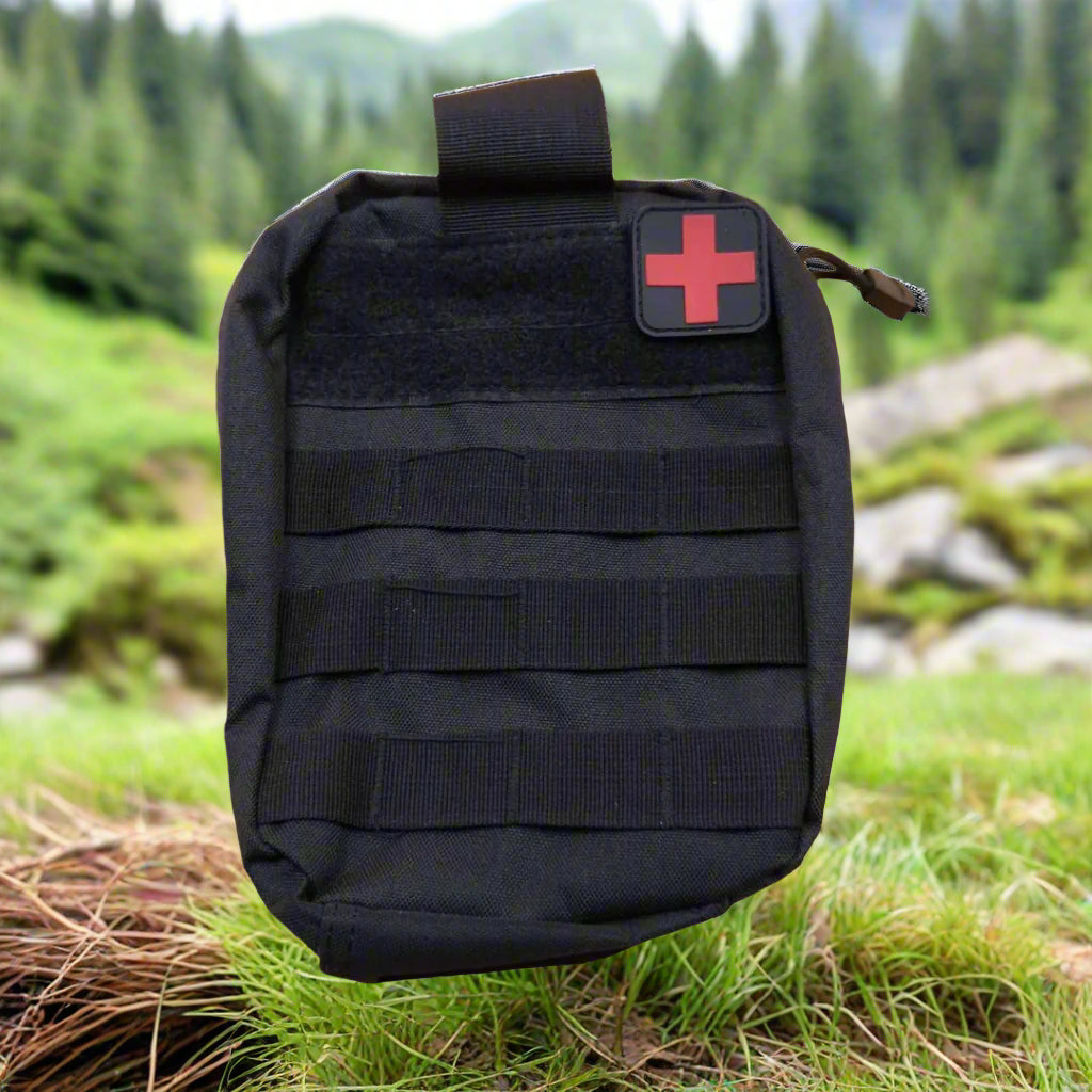 Black tactical pouch with a red cross patch on a beige background