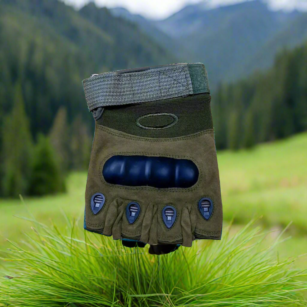 Green glove with blue padding on a sand dune