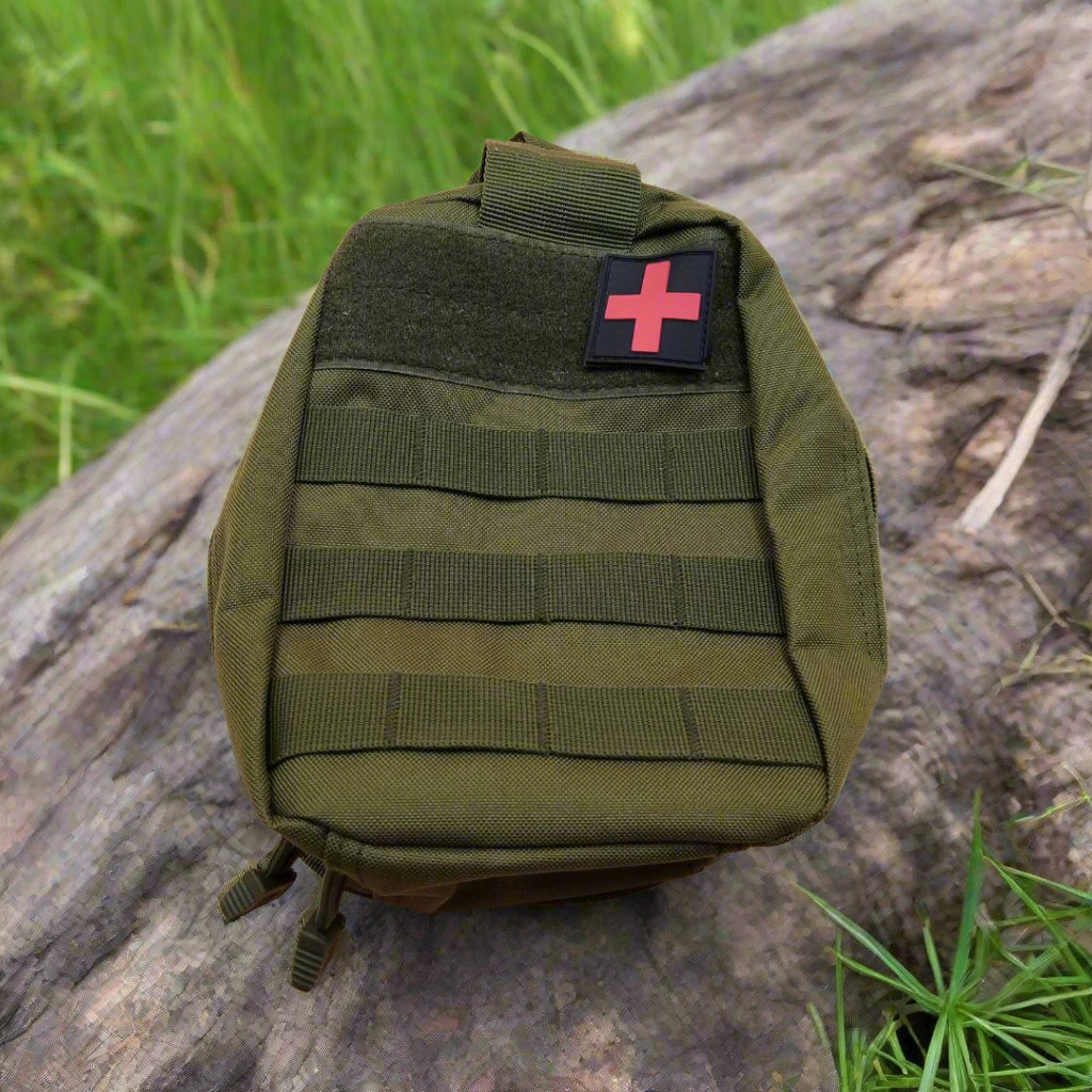 Green tactical backpack with a medical cross patch on a beige background