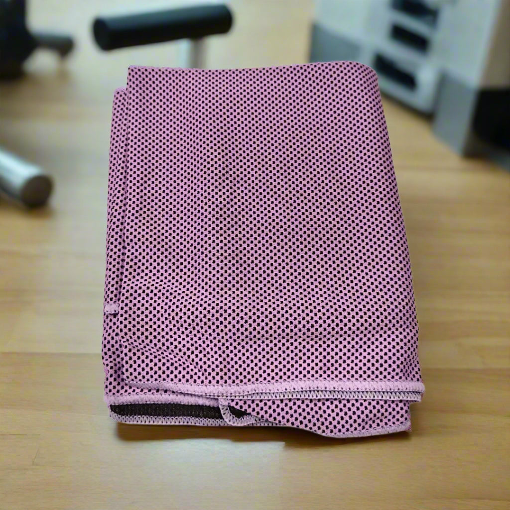 Pink perforated towel on a wooden surface