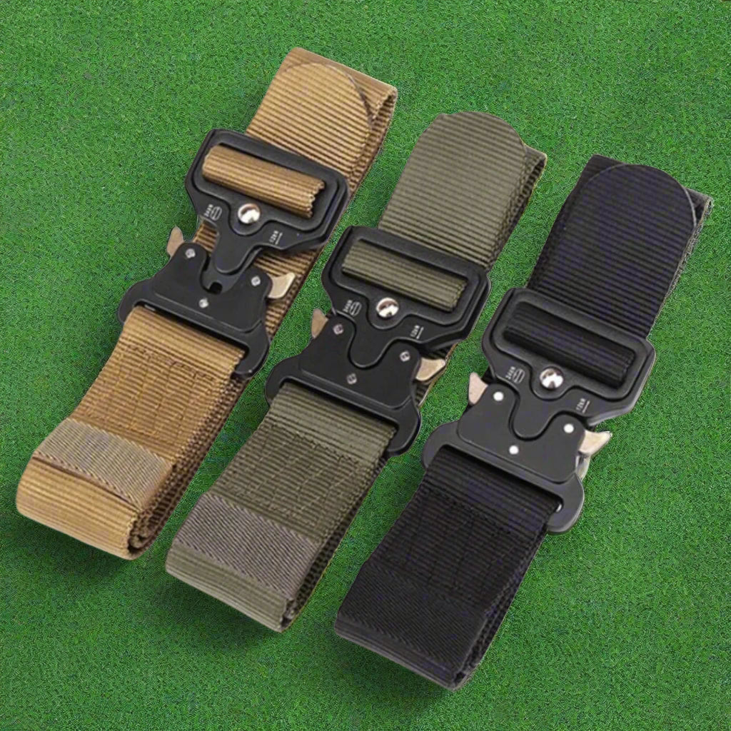 Three tactical belts with different color options on a forest floor