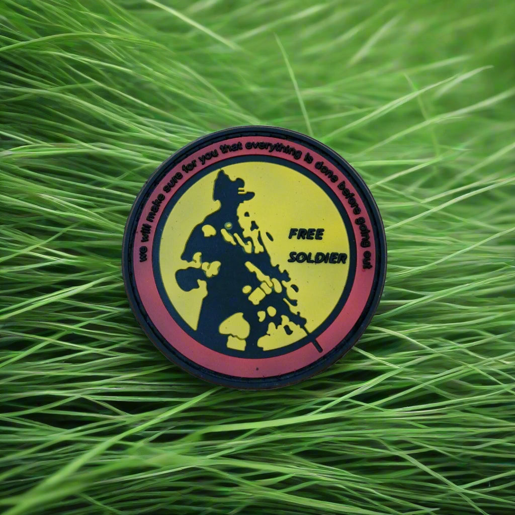 Round badge with a silhouette design on a grass background
