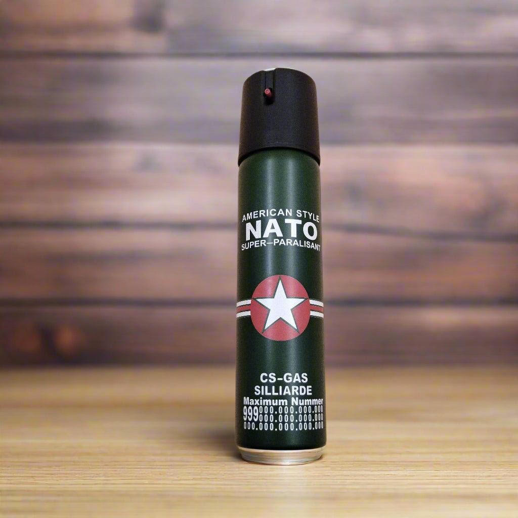 A green canister of pepper spray with a red star logo and text that includes 'NATO' and 'CS-GAS'.
