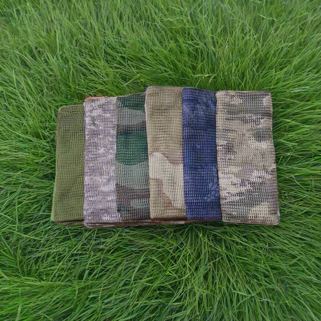 Five camouflage-patterned bags on a forest floor with trees in the background