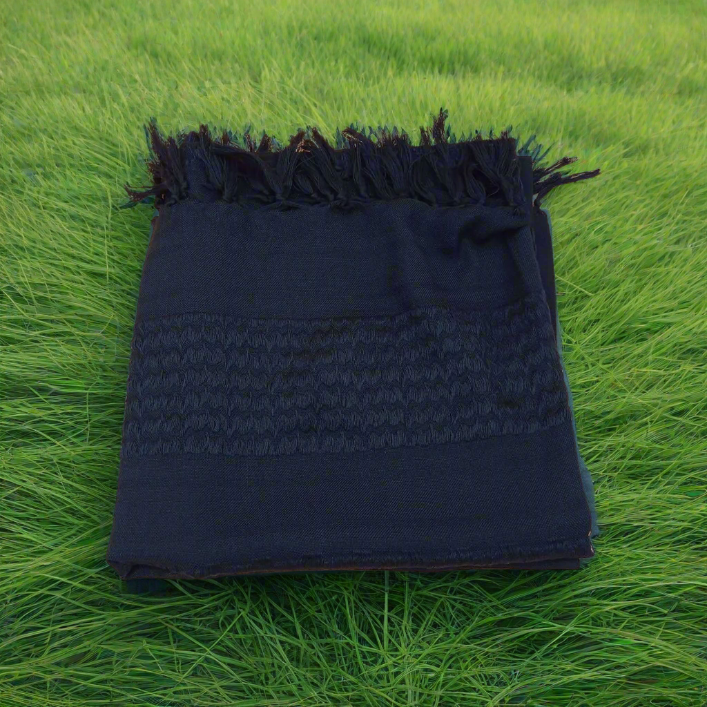 black shemagh surrounded by green grass