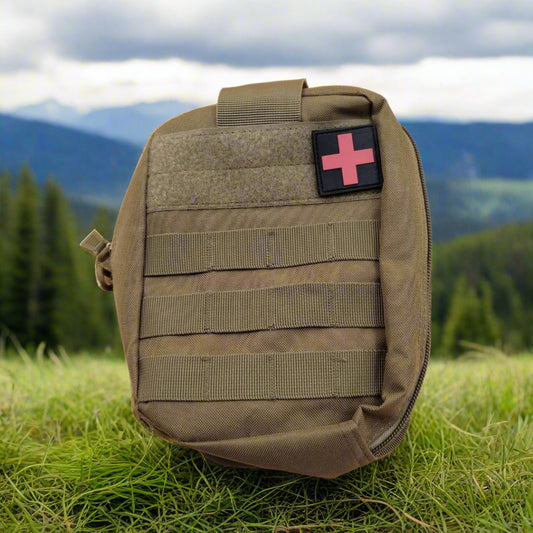 A khaki Red cross molle add on pouch with front and back molle system, carry handle, and a red cross detachable badge displayed on the front.