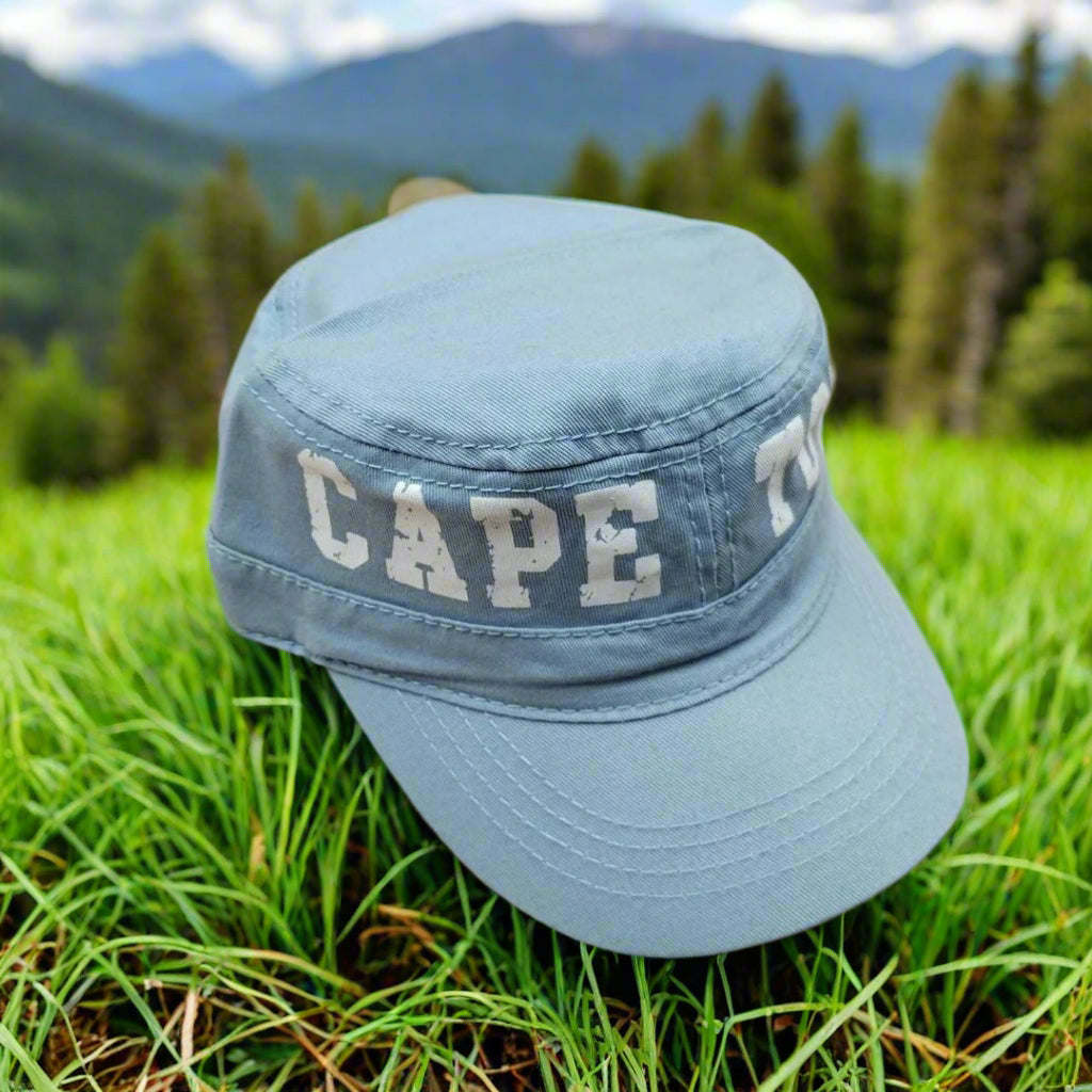 Light blue cap with 'CAPE TOWN' text on a beige background