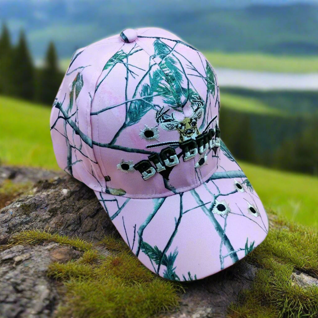 Pink camouflage cap with deer design on a beige background