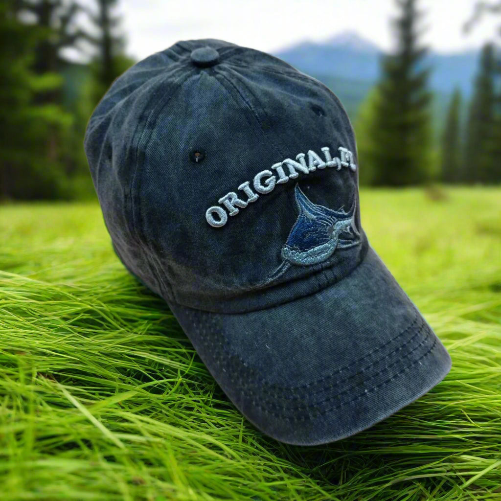 Blue baseball cap with 'ORIGINAL' text and logo on a beige background