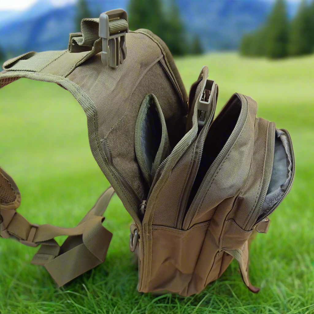 A khaki crossover bag with multiple compartments and zipper closures. It has adjustable straps and appears to be made of canvas material.