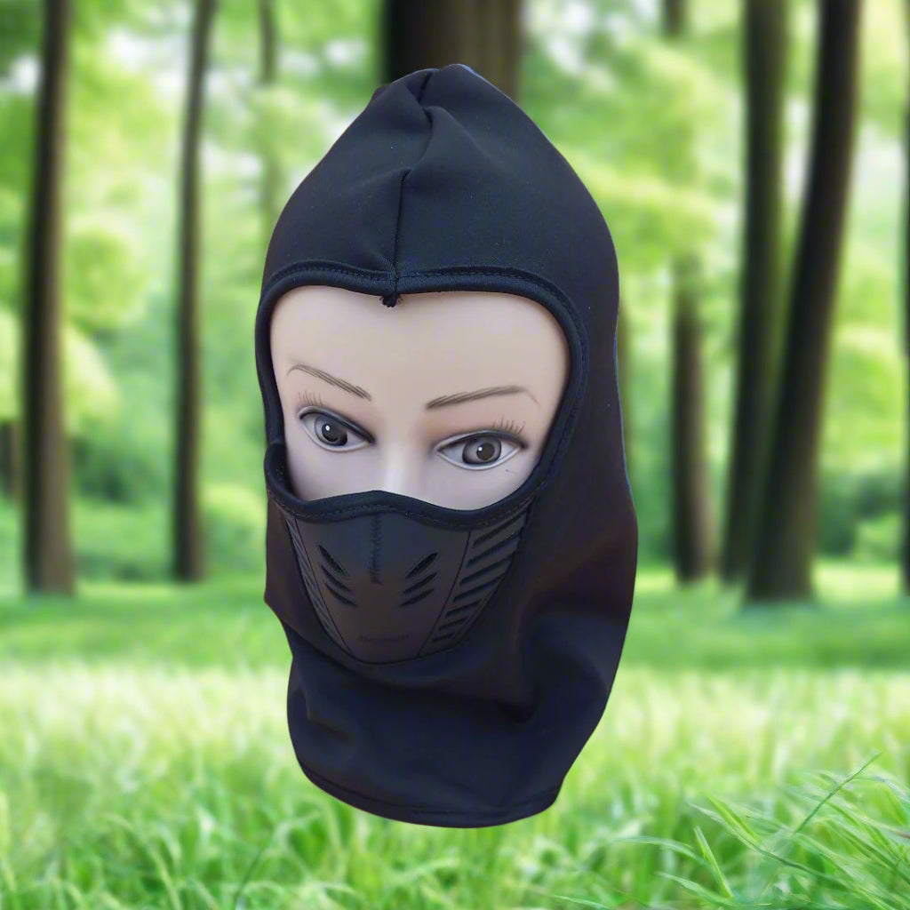Black balaclava on a mannequin head with a forest background