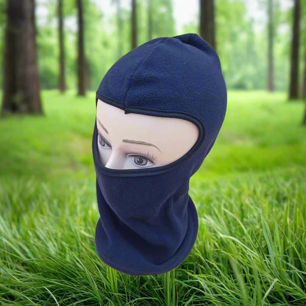 Navy blue balaclava on a mannequin head against a beige background