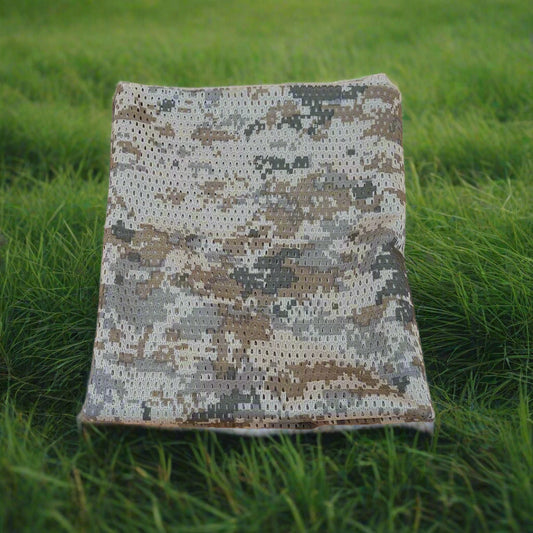 Camouflage-patterned fabric on grass