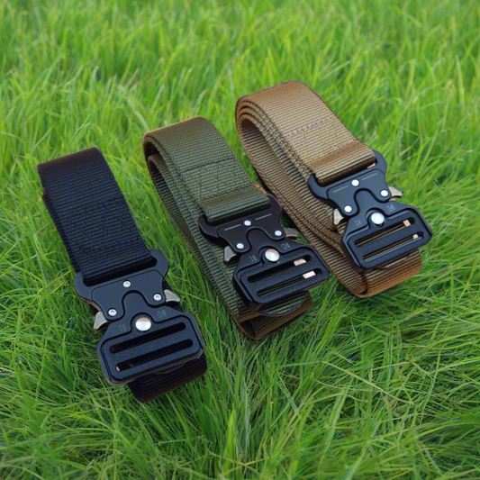 Three tactical belts with buckles on a grass background