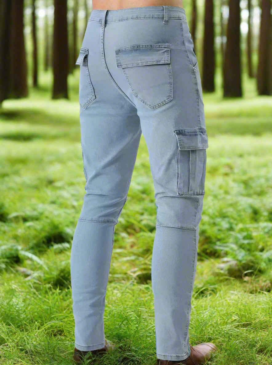 Light blue cargo pants worn by a person standing in a grassy area with trees in the background
