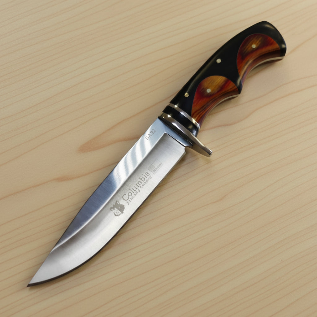 Knife with a wooden handle on a white surface