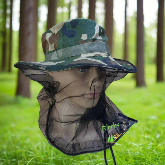 Camouflage hat with insect netting on a mannequin head against a forest background