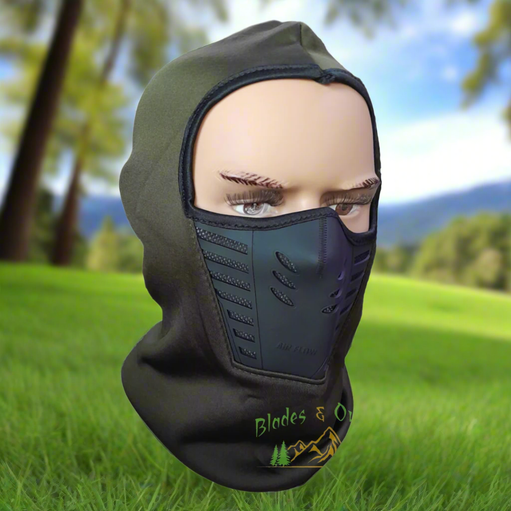 Mannequin head wearing a green and black balaclava with 'Blades & Co' logo against a natural background.