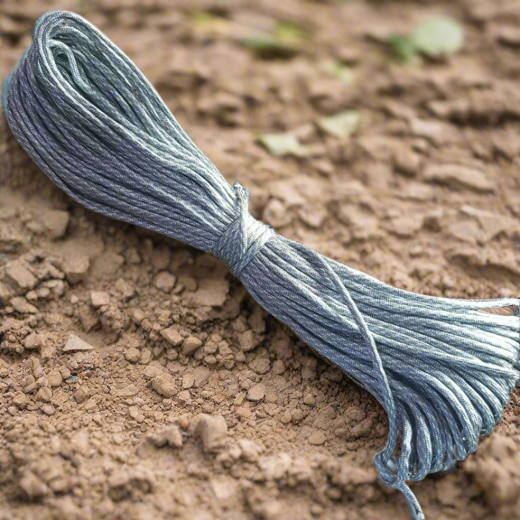Blue string tied into a knot on a brown, textured surface