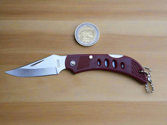 Folding knife with a maroon handle and silver blade