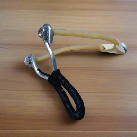 A slingshot with a metal frame and a black grip