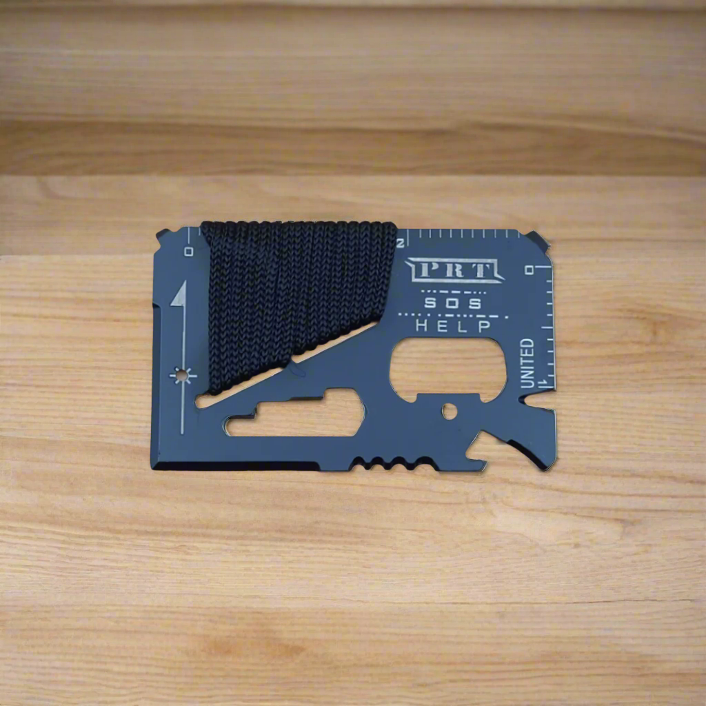 A multi-tool card with integrated tools such as a screwdriver, knife, and saw, alongside a measuring scale, accompanied by a rope. The tool card is displayed against a plain background with a shadow cast below.