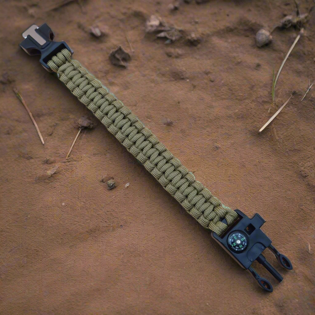 Khaki paracord bracelet with black metal clasp on a brown surface