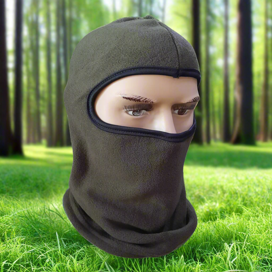 Green balaclava on a mannequin head against a forest background
