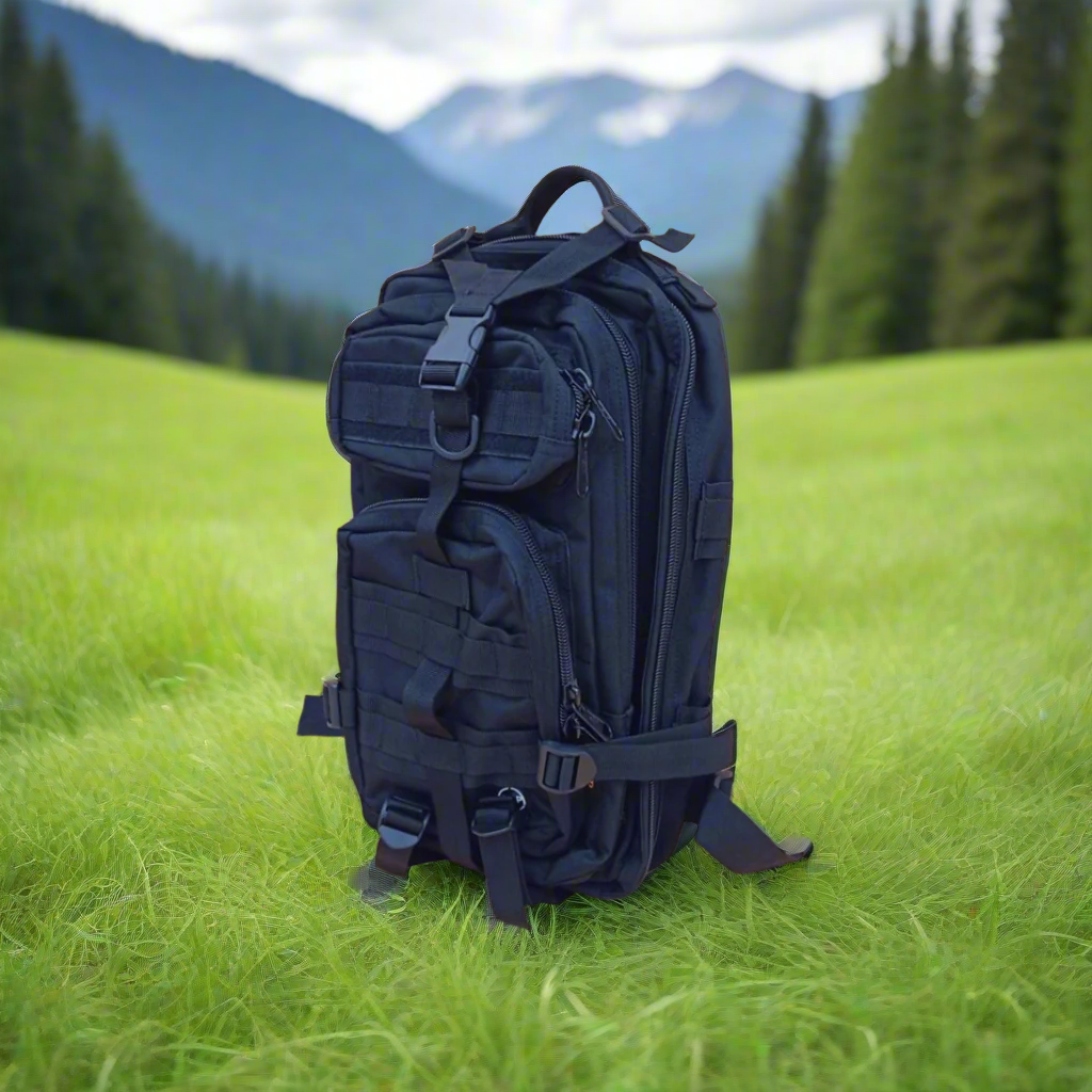 Black tactical backpack on a forest floor with fallen leaves