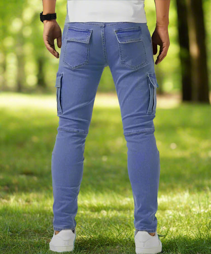 Person wearing blue cargo pants standing on grass with a blurred background
