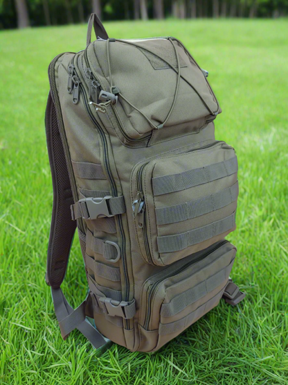 Green tactical backpack on a beige background