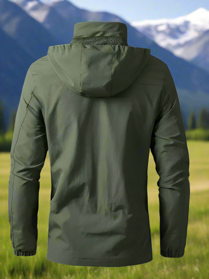 Green jacket with a hood against a mountainous landscape