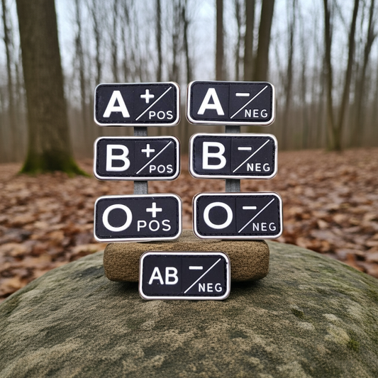 Blood type signs on a rock with a forest background