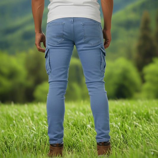 A person standing, wearing blue slim fit stretchable jeans with six pockets and white sneakers.