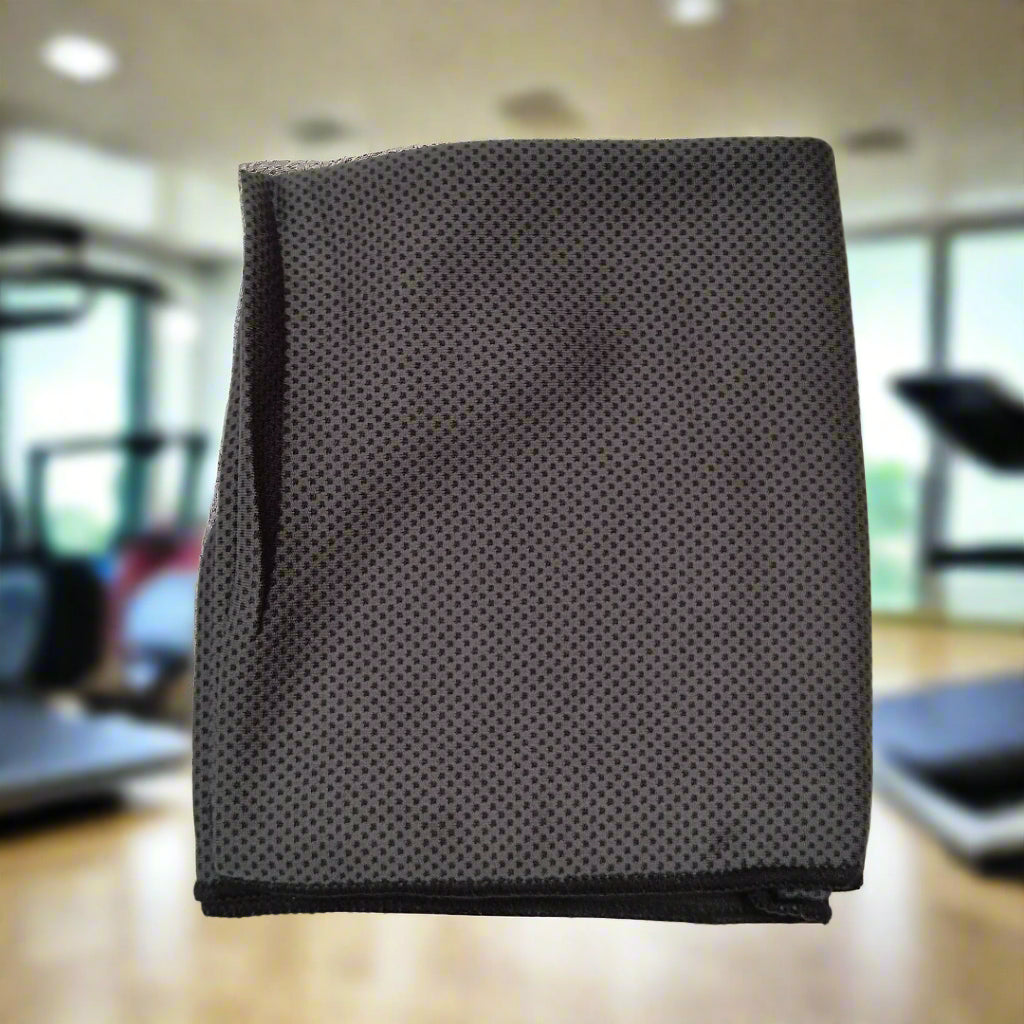 Black perforated towel on a blurred gym background