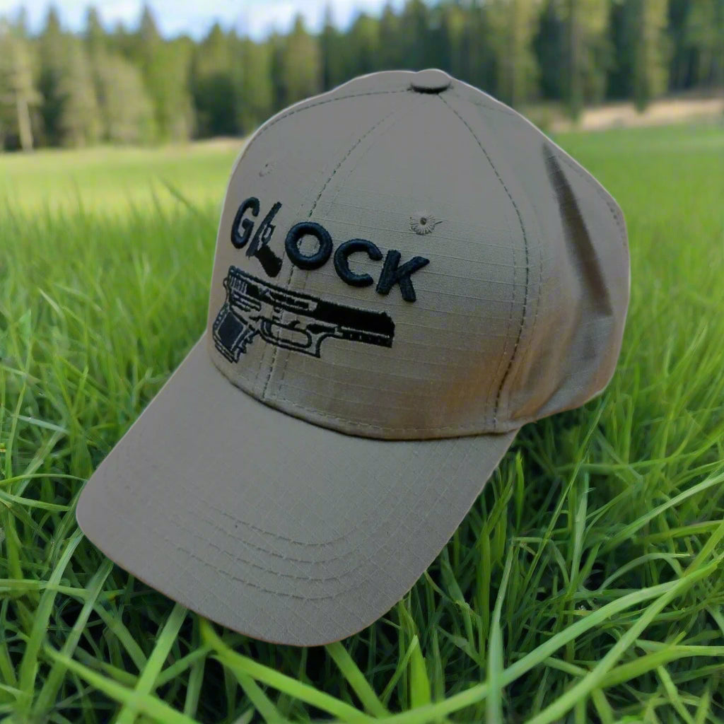 A gray cap with the word 'GLOCK' written on it along with a graphic of a pistol. It features a Velcro adjustable strip.