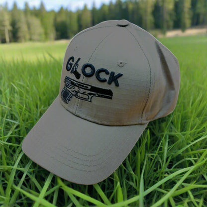 A gray cap with the word 'GLOCK' written on it along with a graphic of a pistol. It features a Velcro adjustable strip.