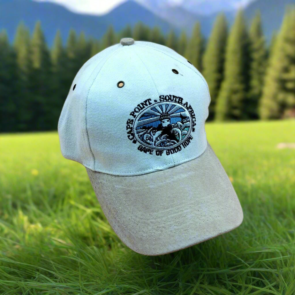 A gray and beige adjustable cap with a logo on the front panel