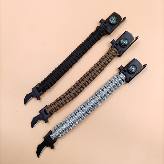 Paracord bracelet with blade and fire starter