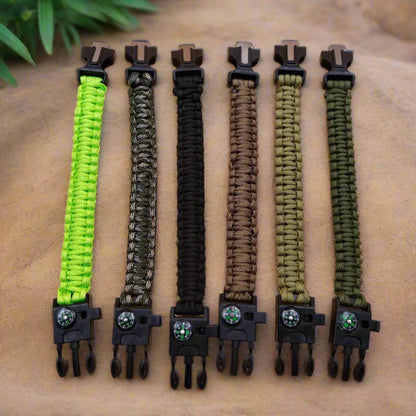 Set of six paracord bracelets in different colors on a wooden surface.
