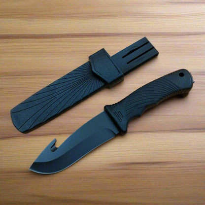 Black knife with sheath on a wooden surface