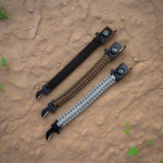 Three paracord bracelets with different patterns on a wooden surface