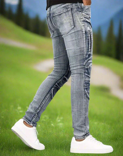 Person wearing light blue jeans and white sneakers on a grassy field with blurred background