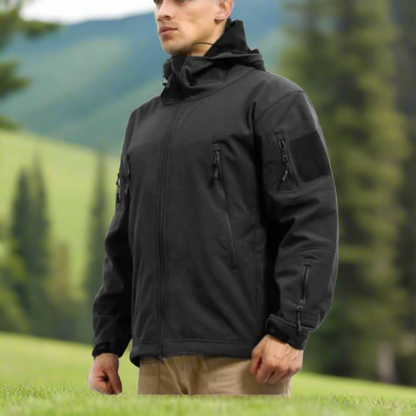 Soft Shell jacket. Jacket has multiple zippers and a hood.