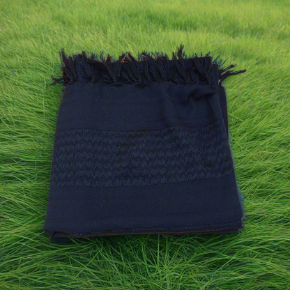 black shemagh surrounded by green grass