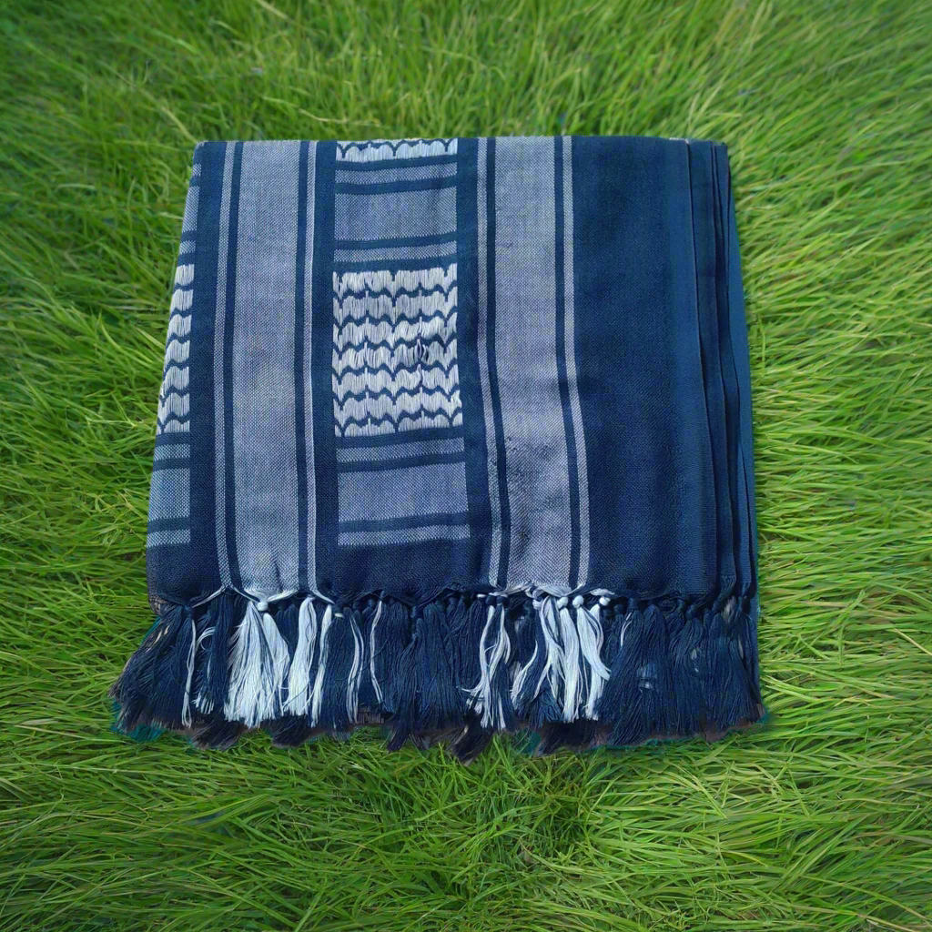 Blue and white striped shemagh surrounded by green grass