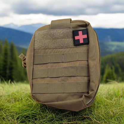 A khaki Red cross molle add on pouch with front and back molle system, carry handle, and a red cross detachable badge displayed on the front.