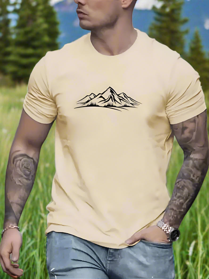 A person wearing a apricot T-shirt with a white mountain design on the front.